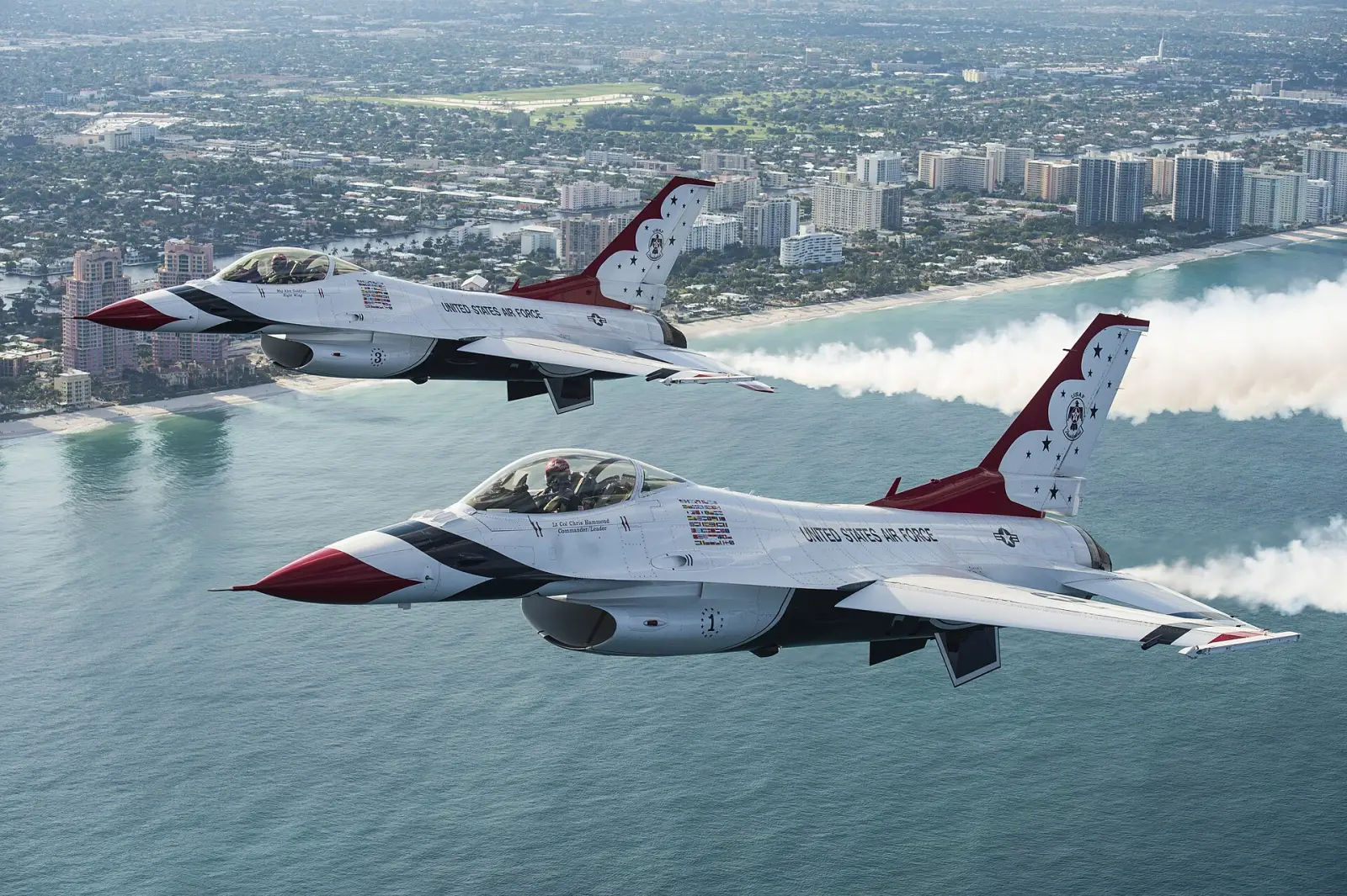 Two U.S. Air Force Thunderbirds F-16s fly along the Fort Lauderdale beachfront.