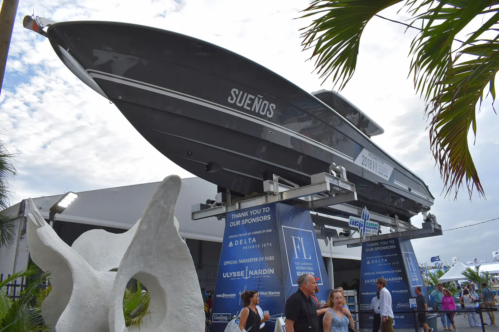 A center console boat on a lift greets visitors at the Fort Lauderdale International Boat Show.