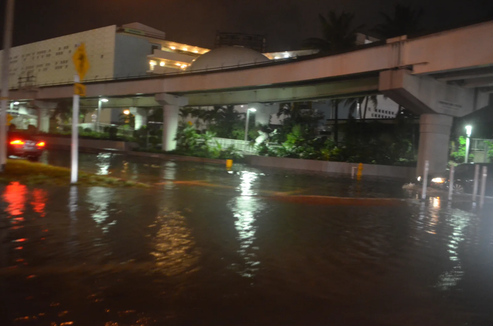 Rain and a king tide flood a street under the Metromover in downtown Miami. The picture does not show Fort Lauderdale.