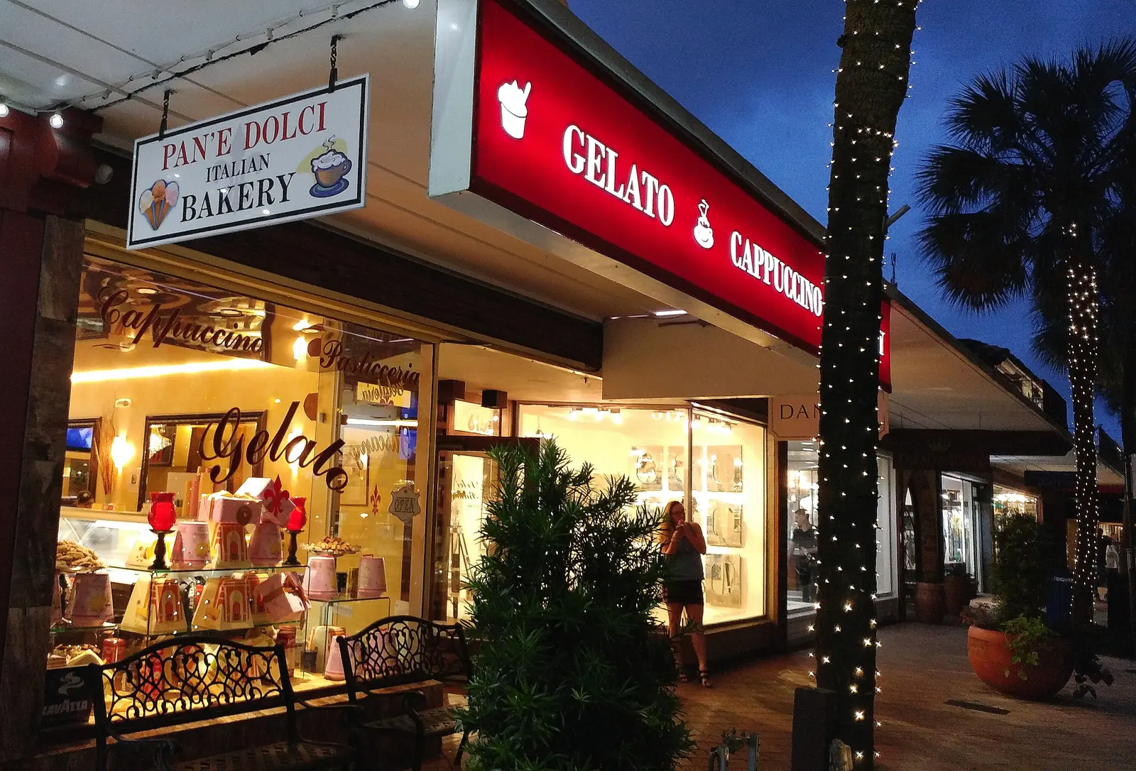 Shops and a gelato bakery on Las Olas Boulevard in Fort Lauderdale in the evening.